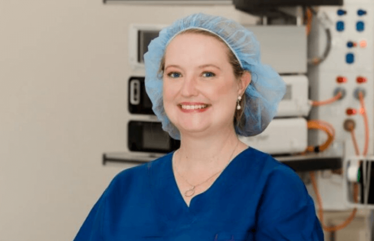 Doctor in blue surgical uniform smile